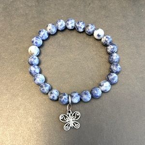Stone beaded blue bracelet with butterfly charm. Elastic